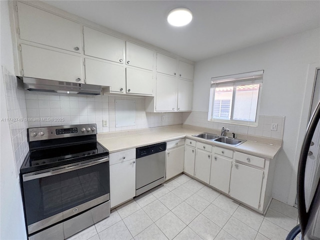 kitchen with sink, decorative backsplash, white cabinets, and appliances with stainless steel finishes