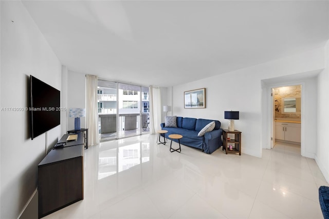 tiled living room featuring a wall of windows