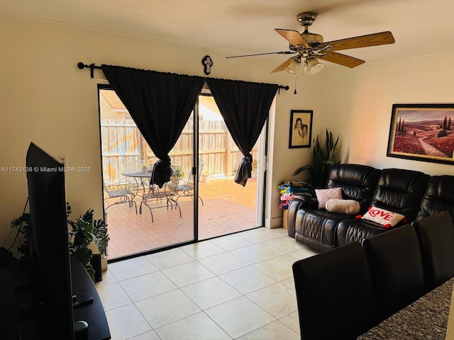 living area with light tile patterned floors and ceiling fan