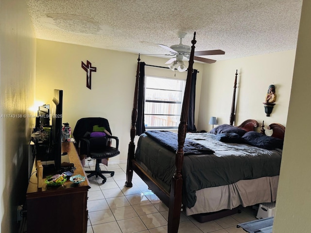 bedroom featuring light tile patterned floors, ceiling fan, and a textured ceiling