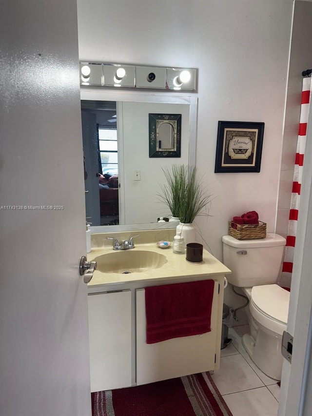 bathroom featuring vanity, toilet, and tile patterned floors