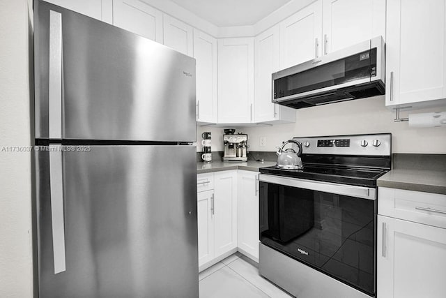 kitchen featuring white cabinetry, appliances with stainless steel finishes, and light tile patterned floors