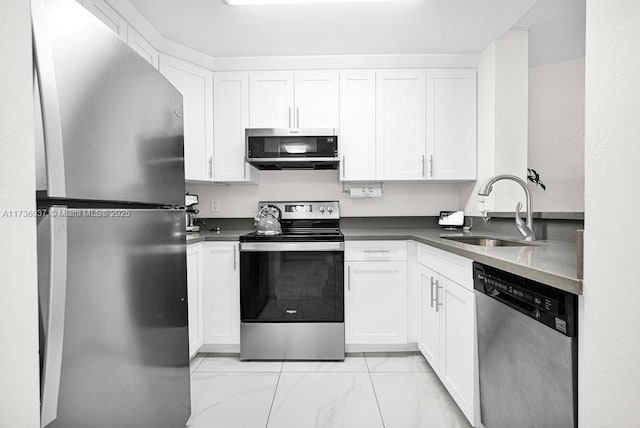 kitchen featuring white cabinetry, appliances with stainless steel finishes, and sink