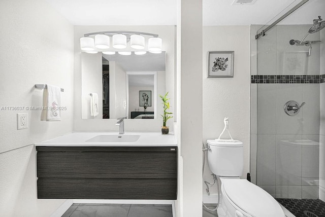 bathroom with a shower with door, vanity, and toilet