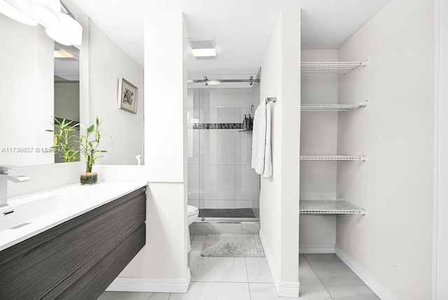 bathroom with vanity, an enclosed shower, and toilet