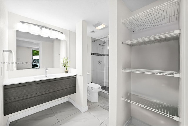 bathroom featuring walk in shower, vanity, and toilet