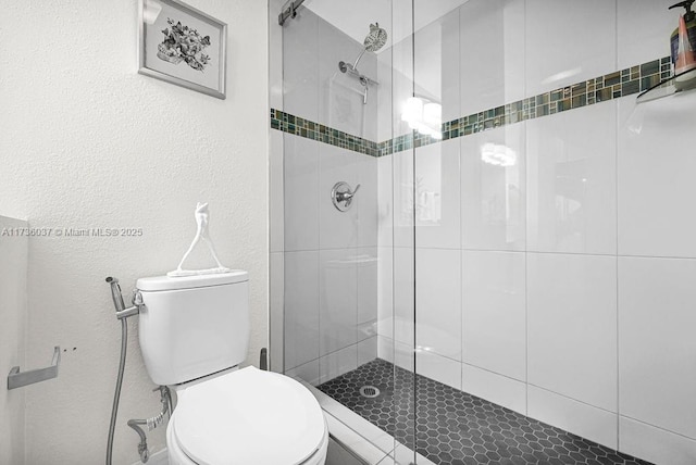 bathroom featuring an enclosed shower and toilet