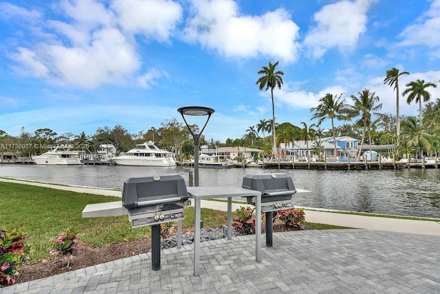 view of patio / terrace with area for grilling, a dock, and a water view