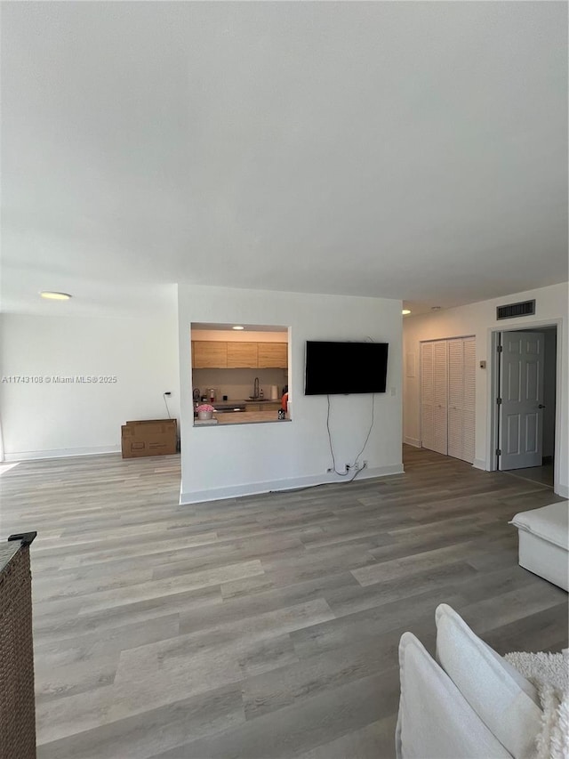 unfurnished living room with light wood-type flooring