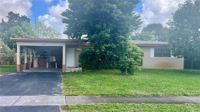 view of front of property with a carport and a front lawn