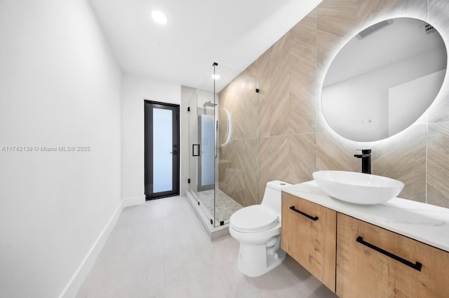 bathroom featuring a stall shower, toilet, vanity, tile walls, and recessed lighting