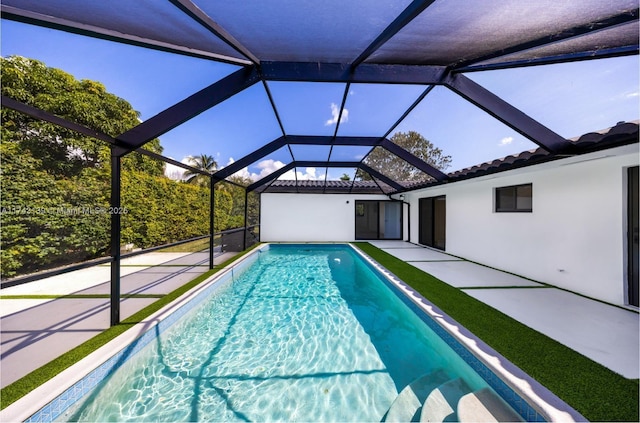 outdoor pool with a patio area and a lanai