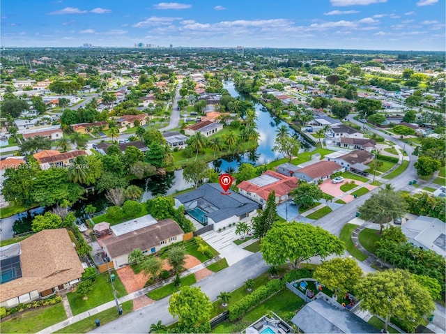 birds eye view of property with a residential view and a water view