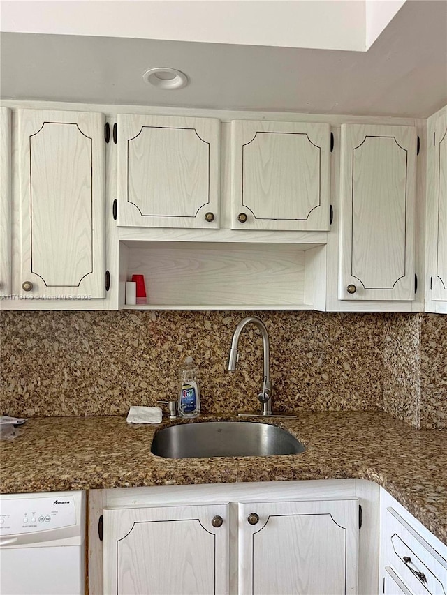 kitchen featuring tasteful backsplash, sink, and white dishwasher