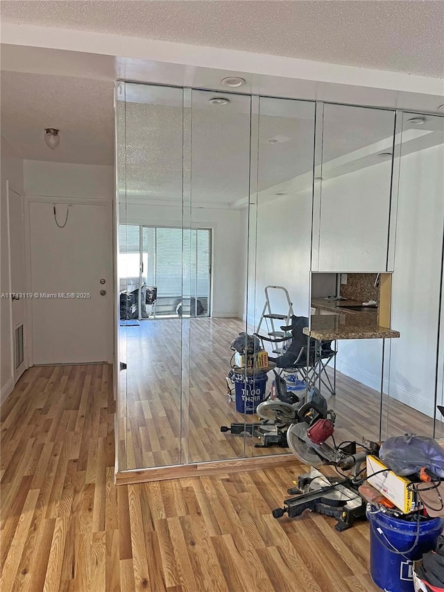 interior space featuring hardwood / wood-style flooring and a textured ceiling