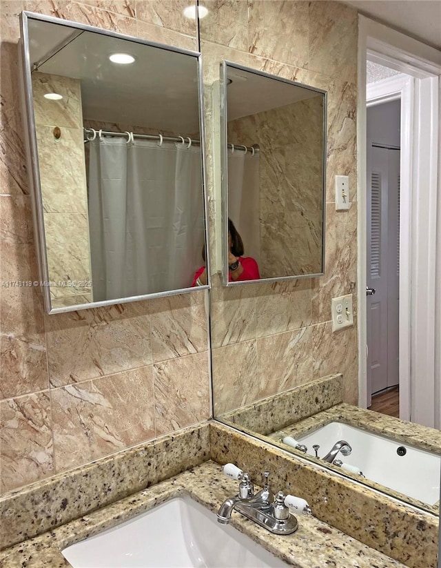 bathroom with walk in shower and vanity