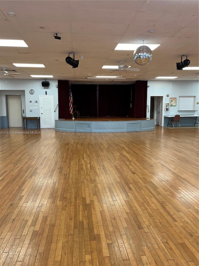 miscellaneous room featuring hardwood / wood-style flooring and a paneled ceiling