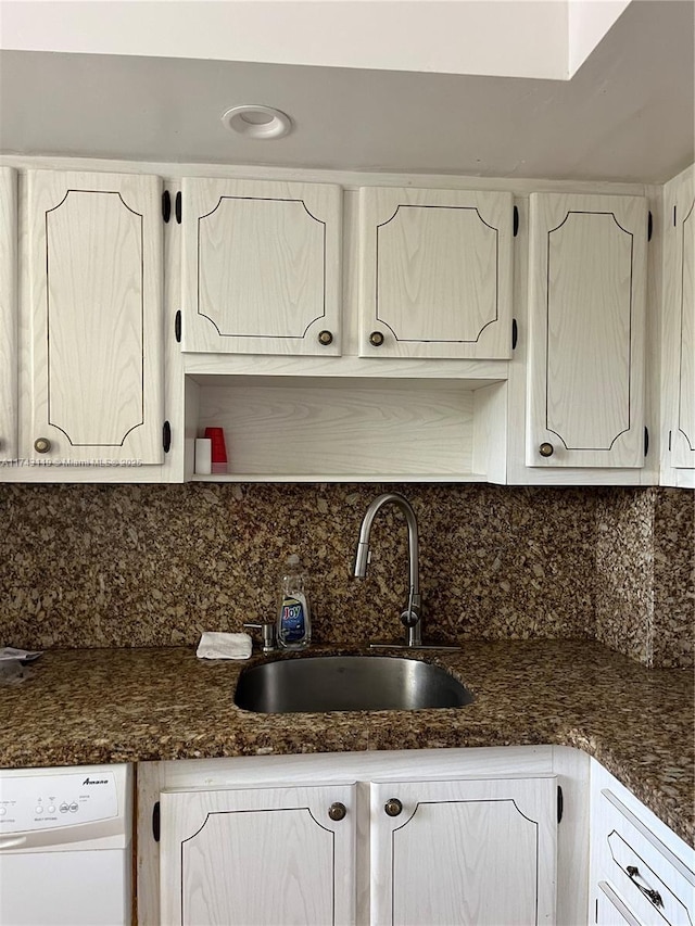 kitchen with white dishwasher, sink, and backsplash