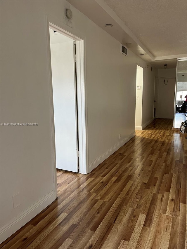 unfurnished room with hardwood / wood-style floors