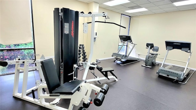 exercise room featuring a drop ceiling
