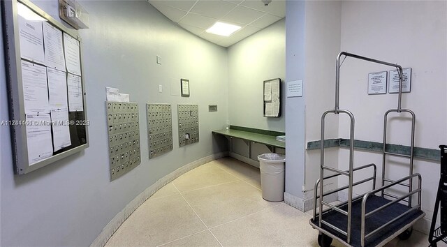 bathroom with mail boxes and a drop ceiling