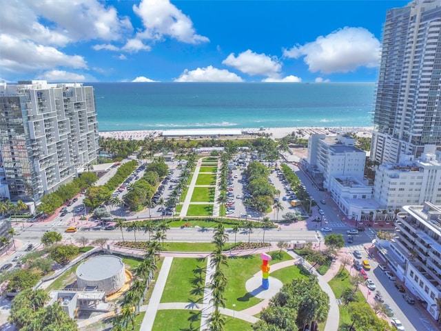 bird's eye view with a water view and a beach view