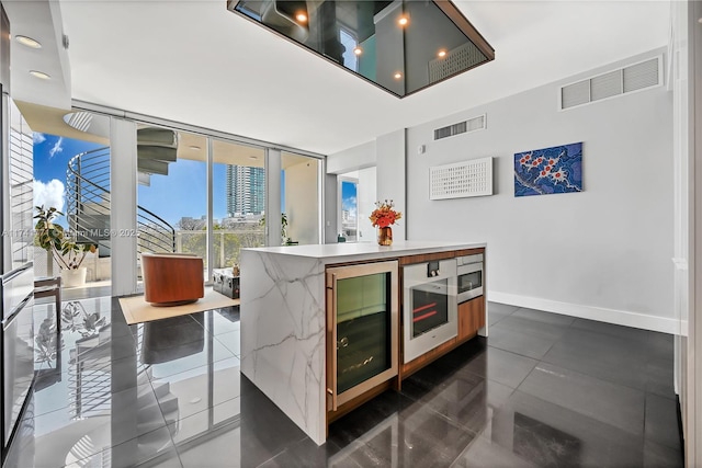 kitchen featuring wine cooler, floor to ceiling windows, and a kitchen island