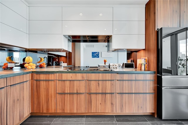 kitchen with stainless steel gas stovetop and white cabinets