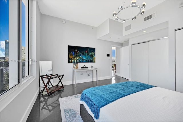 bedroom featuring a chandelier and a closet