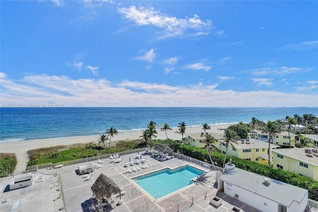 drone / aerial view featuring a water view and a view of the beach