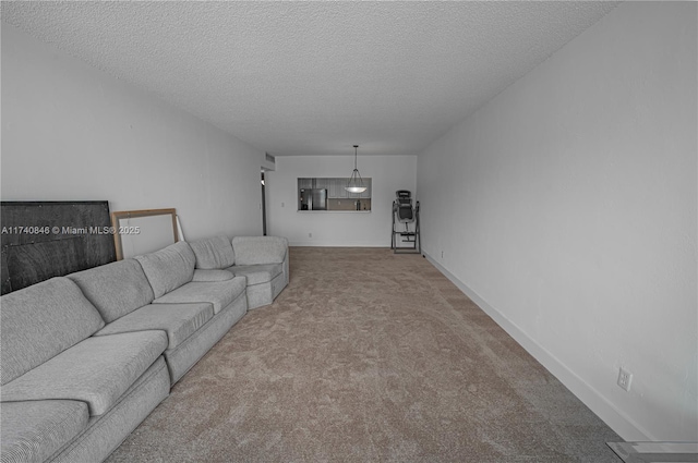 carpeted living room with a textured ceiling