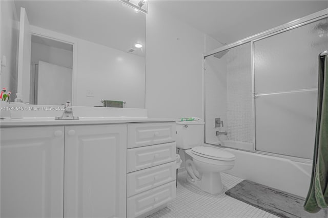 full bathroom with vanity, tile patterned floors, shower / bath combination with glass door, and toilet