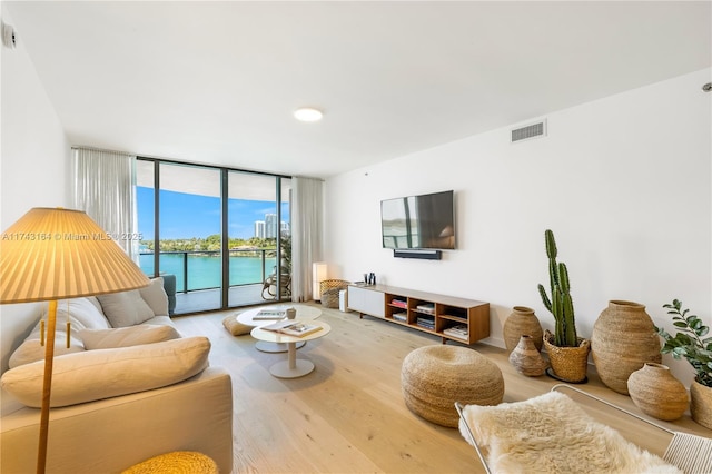 1135 103rd St Unit 602, Bay Harbor Islands, FL 33154 - living room featuring expansive windows and wood finished floors