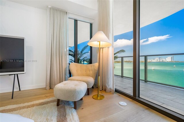 1135 103rd St Unit 602, Bay Harbor Islands, FL 33154 - sitting room featuring wood finished floors and a water view