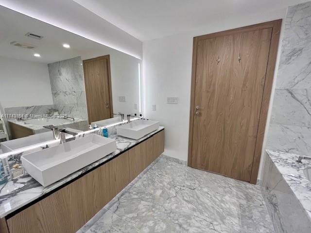 bathroom featuring vanity and a bathing tub