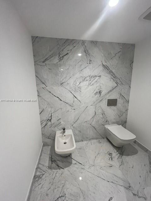 bathroom featuring a bidet and toilet