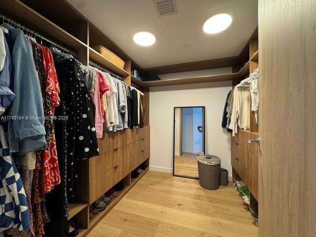 spacious closet featuring light hardwood / wood-style flooring