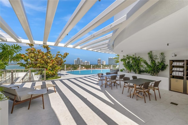 1135 103rd St Unit 602, Bay Harbor Islands, FL 33154 - view of patio featuring a community pool, outdoor dining area, a pergola, a city view, and a water view