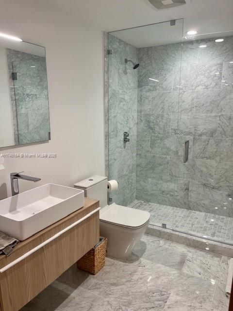 bathroom with vanity, an enclosed shower, and toilet