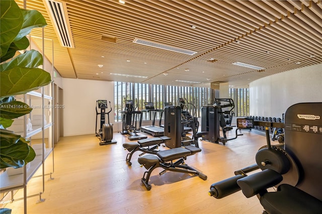 1135 103rd St Unit 602, Bay Harbor Islands, FL 33154 - workout area featuring healthy amount of natural light, expansive windows, and wood finished floors