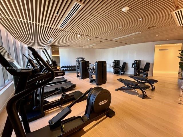 exercise room with light wood-type flooring