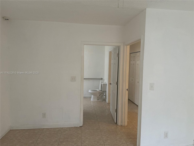 hall with light tile patterned floors