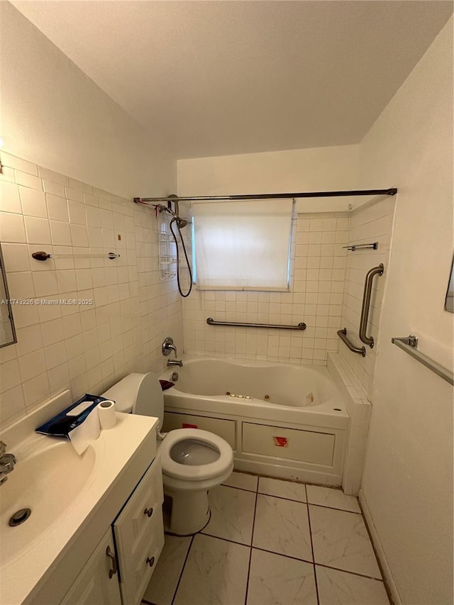 bathroom with toilet, vanity, tile walls, marble finish floor, and a combined bath / shower with jetted tub