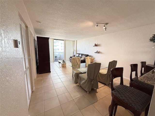 dining room featuring light tile patterned flooring and a textured ceiling