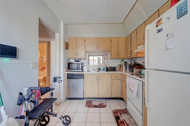 kitchen featuring appliances with stainless steel finishes, light brown cabinetry, sink, and light tile patterned floors