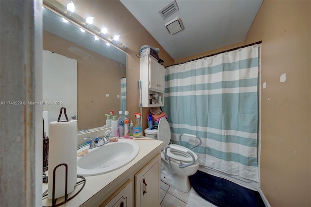 bathroom with vanity, tile patterned flooring, and toilet