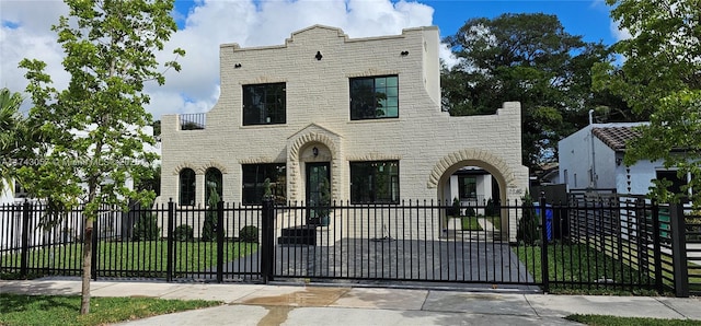 view of front of home with a fenced front yard and a gate