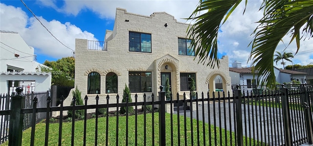 view of front of home featuring stone siding and a fenced front yard