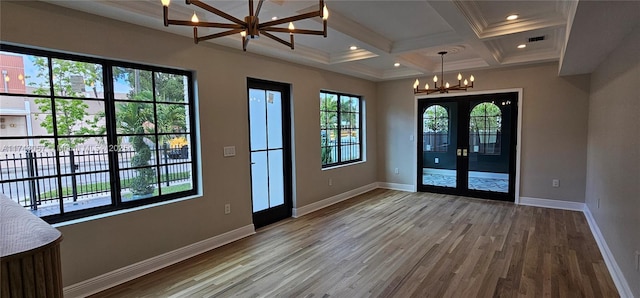 doorway with beam ceiling, coffered ceiling, wood finished floors, an inviting chandelier, and baseboards