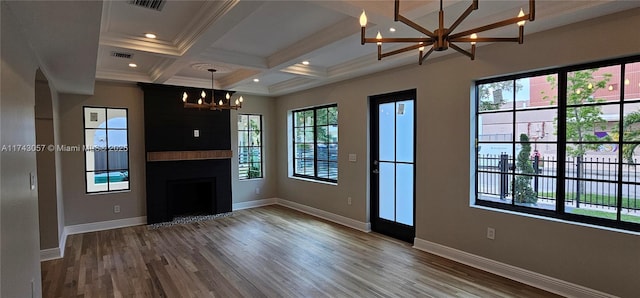 unfurnished living room featuring baseboards, a chandelier, beam ceiling, a fireplace, and coffered ceiling